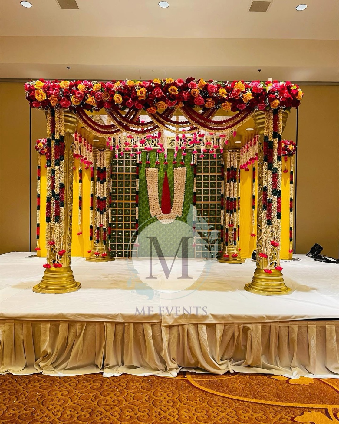 Grand gold-pillar mandap with rose canopy