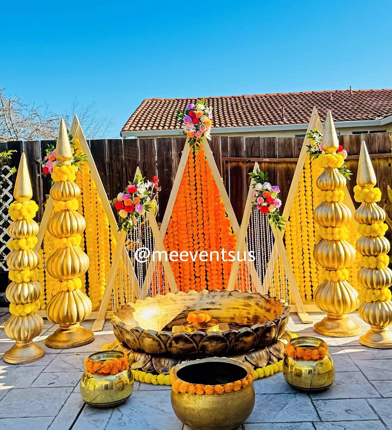 Daytime haldi decor with marigold and brass urli