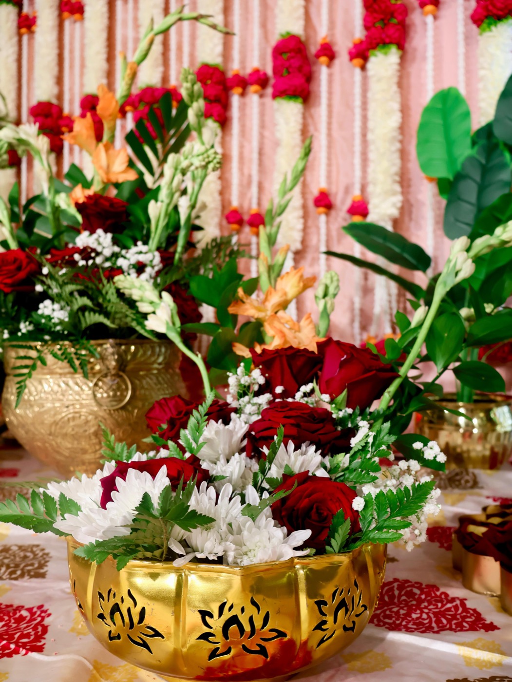 Gold lotus bowl with red roses and white blooms